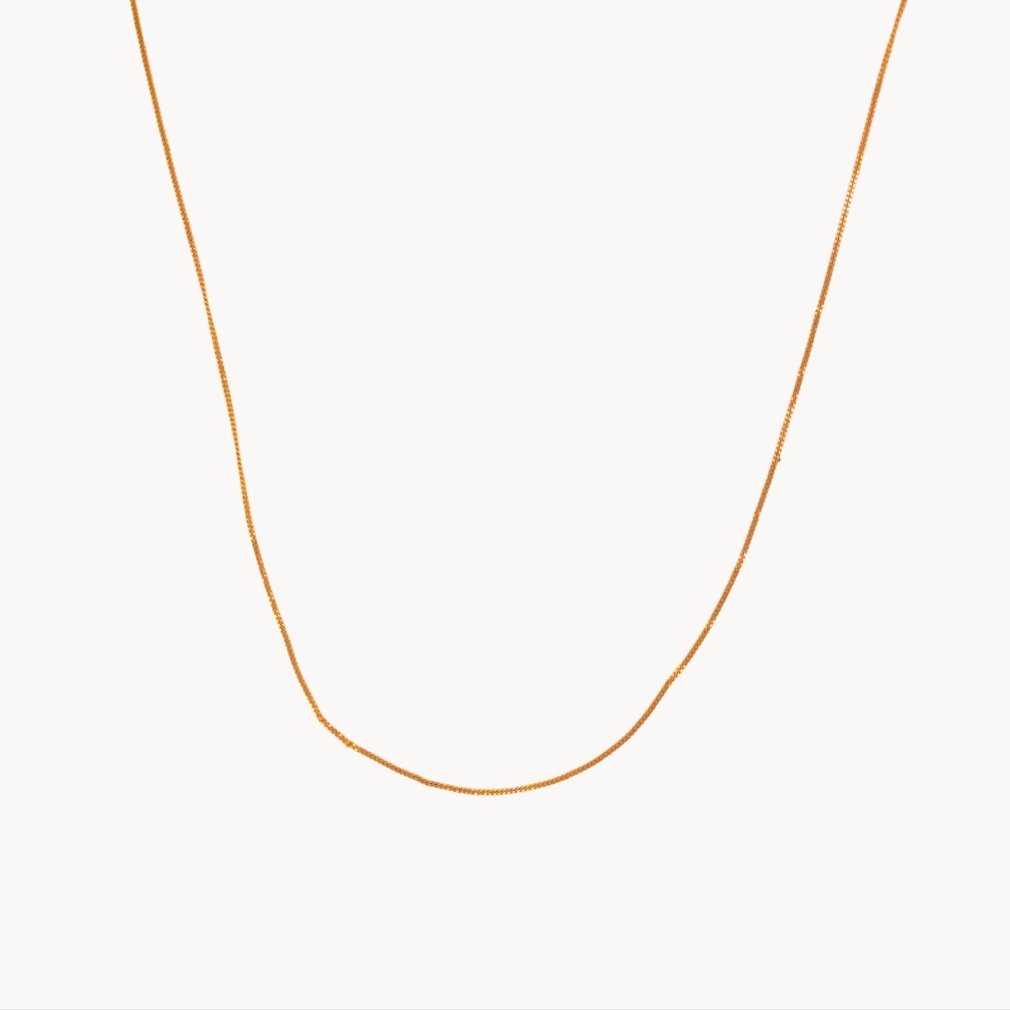 Gold necklace on a white background
