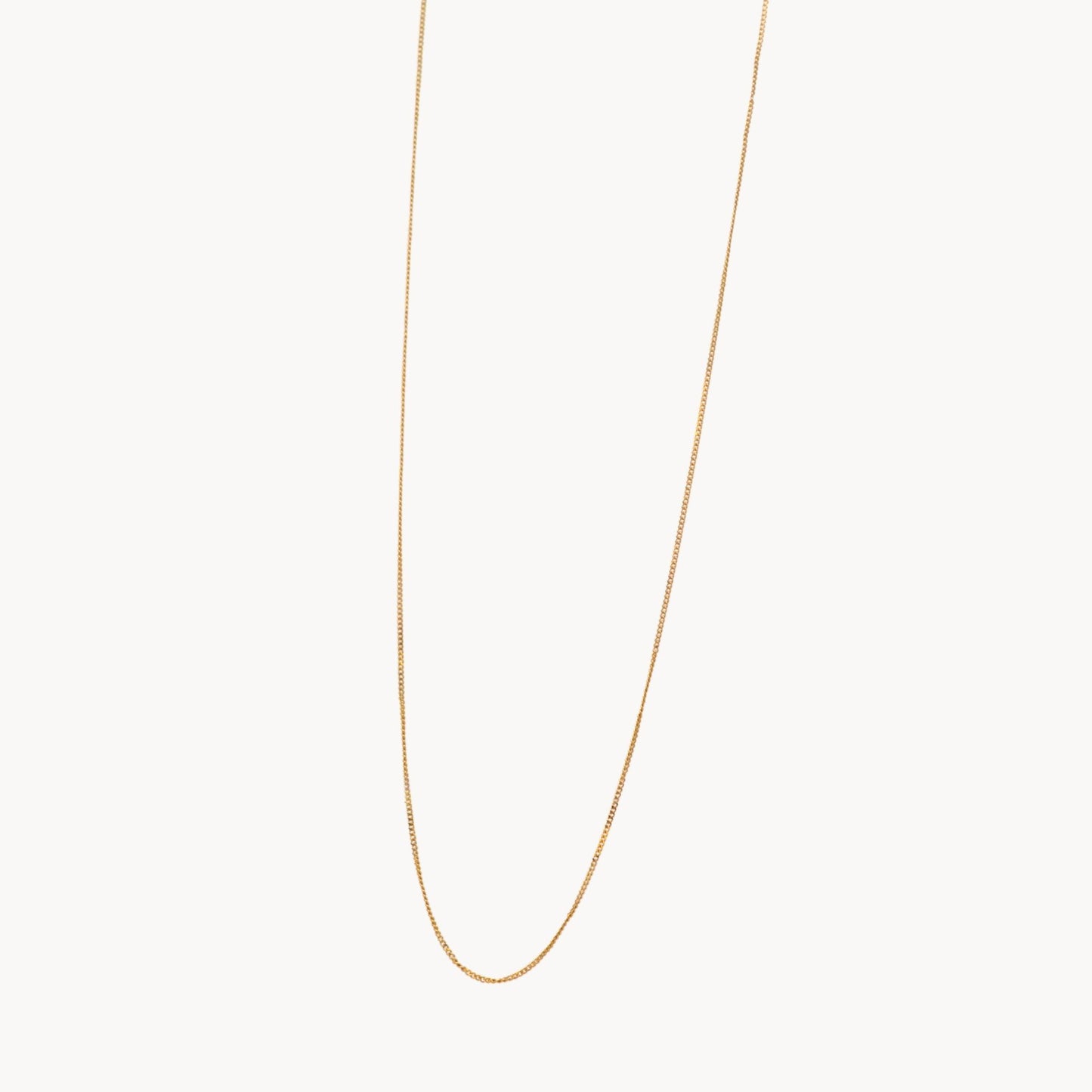 Gold chain necklace on a white background