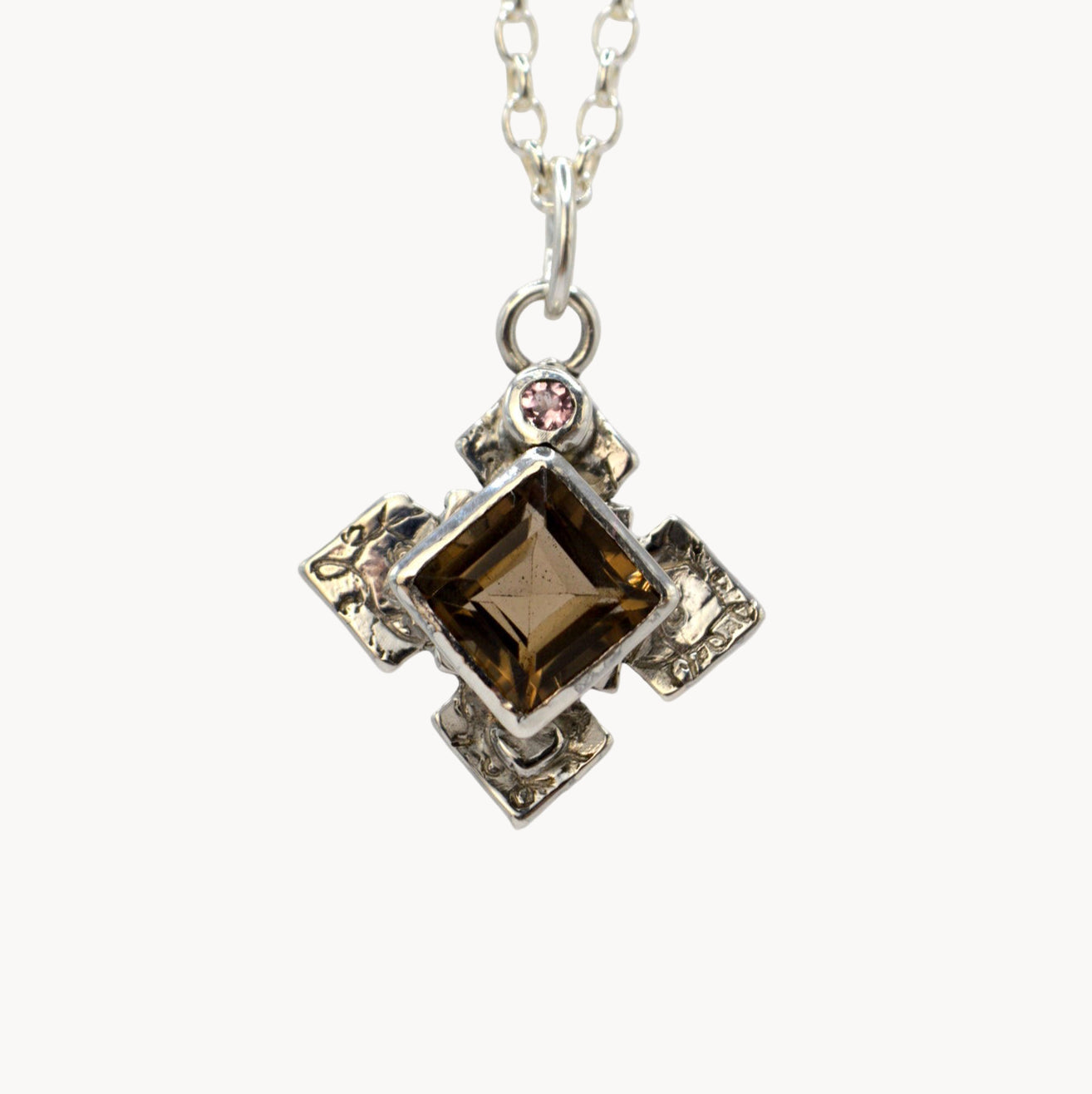 Necklace with a square pendant featuring a brown gemstone on a white background
