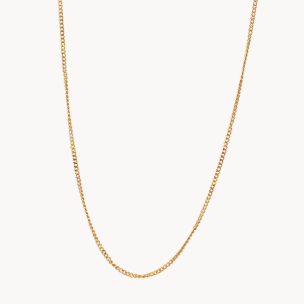Gold chain necklace on a white background