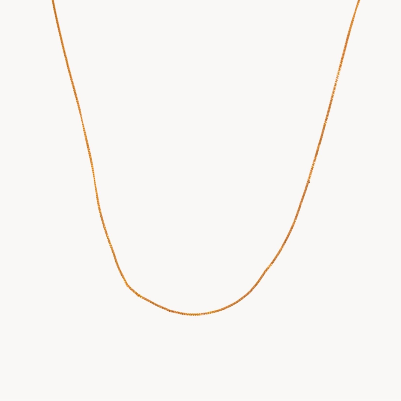 Gold necklace on a white background