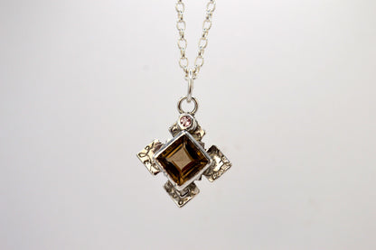 Necklace with a pendant featuring a brown gemstone on a white background