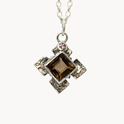 Necklace with a square pendant featuring a brown gemstone on a white background
