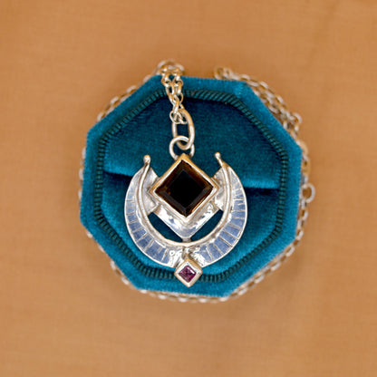 Necklace with blue pendant on a brown background