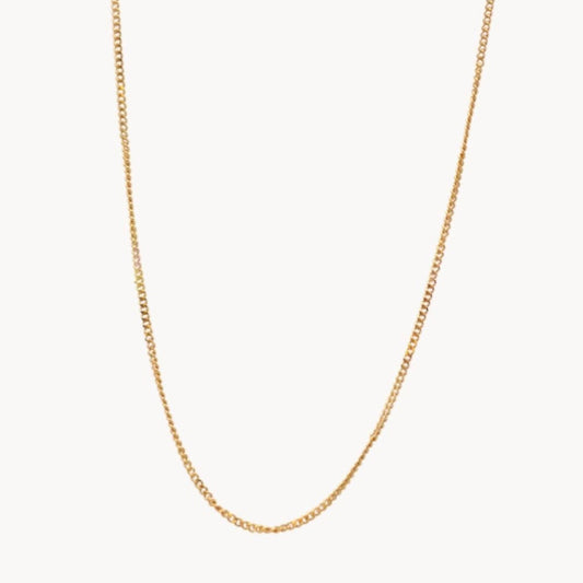 Gold chain necklace on a white background